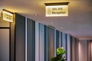 un panneau suspendu au plafond d'une pièce avec des rayures dans l'établissement Aerotel Kuala Lumpur (Airport Hotel) - Gateway@klia2, à Sepang