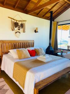a bedroom with a large wooden bed in a room at Chalés Terras Altas in Gonçalves