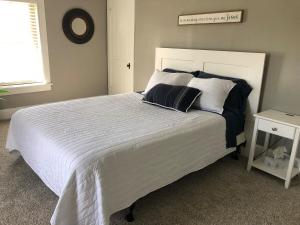 a bedroom with a large white bed with pillows at Walnut Valley Farm guesthouse in Canton