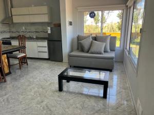 a living room with a couch and a table at Rancho la Pradera in Deán Funes