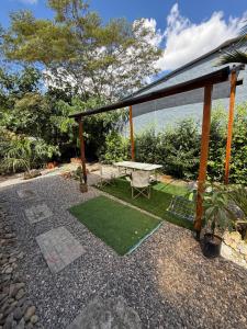 a patio with a picnic table and grass at Espectacular Casa-Bonobohouse al lado del rio con reserva natural in Acacías
