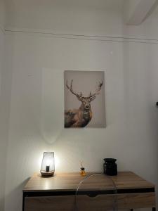 a painting of a deer hanging on a wall at Beautiful flat in Issy les Moulineaux - Close to Paris in Issy-les-Moulineaux +2 photos