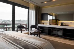 a hotel room with a bed and a desk at Ville Saint Germain Apart Hotel & Spa in Carilo +135 photos