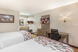 a hotel room with two beds and a desk at Red Roof Inn Durham - Duke Univ Medical Center in Durham +25 photos