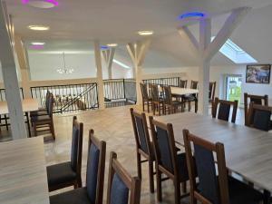 a dining room with wooden tables and chairs at Agroturystyka Relax na Kaszubach in Żuromino