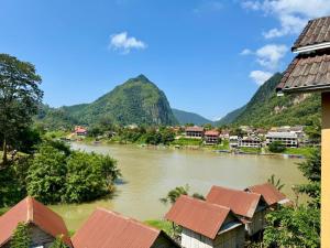 a view of a river with mountains in the background at Nong Khiaw Meexai Sunset View in Nongkhiaw