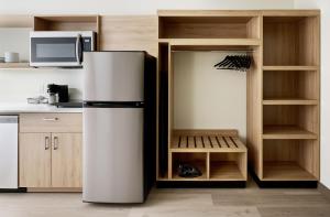 a kitchen with a refrigerator and a microwave at Hyatt Studios Huntsville in Huntsville +15 photos