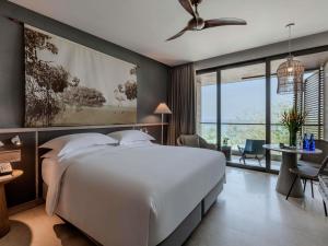 a bedroom with a large white bed and a large window at Sofitel Barú Cartagena in Cartagena de Indias +212 photos