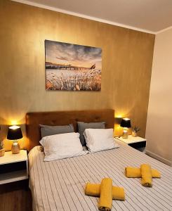 a bedroom with a large bed with yellow pillows at House - Linini in Mārupe