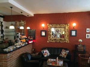 a bar with a mirror and a leather couch at B&B Fotić in Zagreb