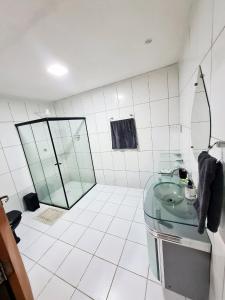 a bathroom with a glass sink and a shower at Casa completa Petrolina-PE in Petrolina