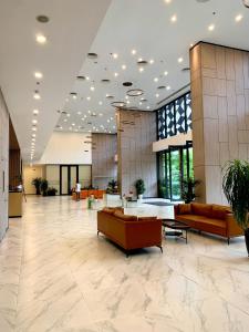 a lobby with couches and tables in a building at Westlake view condominium in Hanoi +34 photos
