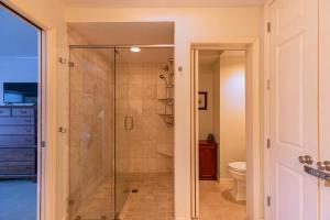 a glass shower in a bathroom with a toilet at Chetola: Holly 4 in Blowing Rock +30 photos