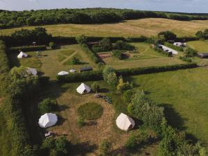 an overhead view of a farm with tents in a field at Honeysuckle Shepherds Hut at Blean Bees Eco Glamping in Canterbury +9 photos