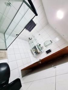 a room with a chair and a tile wall at Casa completa Petrolina-PE in Petrolina +6 photos