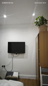a flat screen tv hanging on a white wall at Stylish Self Contained Unit - High Wycombe in High Wycombe