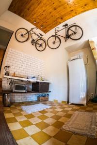 ブルマジーニョにあるLoft com vista para montanha e lagoa 2 - Inhotimの冷蔵庫のあるキッチンの天井から自転車が2台ぶら下がっている