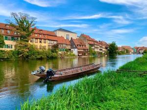 a boat on a river in a city at FeWo Viktoria in Bamberg