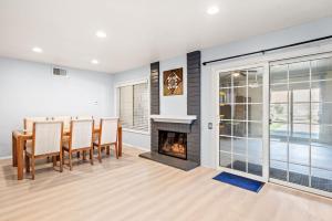 a dining room with a fireplace and a table and chairs at Near ONT Ontario Oasis Designer Home w Garden Park in Ontario