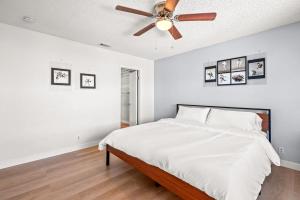 a bedroom with a bed with a ceiling fan at Near ONT Ontario Oasis Designer Home w Garden Park in Ontario +66 photos