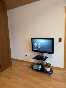 a flat screen tv sitting on a stand in a room at Ferienwohnung Lydia in Olpe