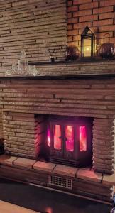a model of a brick fireplace with red lights at Lovely Home In Sauda With Wifi in Sauda