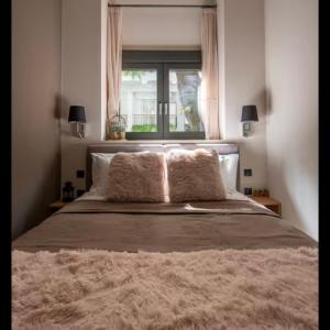 a bedroom with a large bed with a window at CITY Loft Lux in Thessaloniki