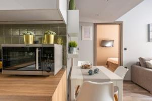 a kitchen and living room with a microwave at CITY Loft Lux in Thessaloniki +13 photos