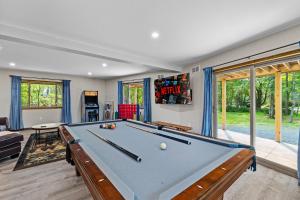 a pool table in a living room with a pool at Hot Tub and Community Beach Albrightsville Home! in Albrightsville