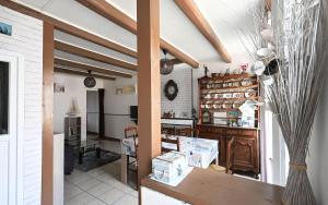 a living room with a table and a kitchen at Villa des Ormeaux in Les Moulins de la Boire +6 photos