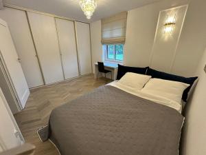 a bedroom with a bed and a chair and a window at Agroturystyka Polanka in Olesiec