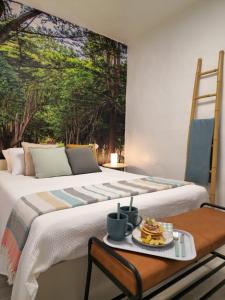 a bed with a plate of food on a table at La Herbolera Vv Apartamento in Teror