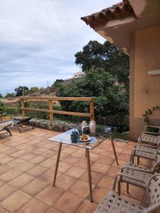 a patio with a table and chairs on a patio at La Herbolera Vv Apartamento in Teror