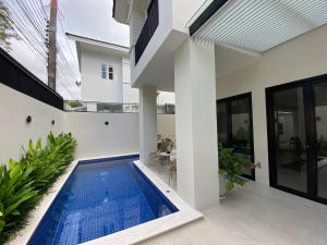 a swimming pool in the backyard of a house at Palazzo 126 Luxury 5BR Pool Villa in Patong in Patong Beach