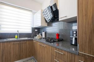 a kitchen with a sink and a stove top oven at Spacious, 3BD City Center Apt in La Julia