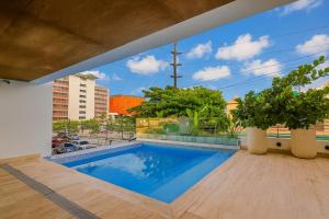a swimming pool with a view from a building at Spacious, 3BD City Center Apt in La Julia