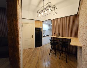 a kitchen with a table and chairs in a room at HOSTAL ANDREA GRANVIA in Madrid