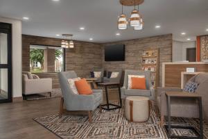 a living room with chairs and a tv in a room at Candlewood Suites Annapolis by IHG in Annapolis