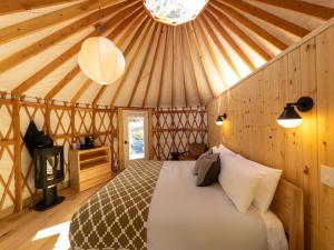 a bedroom with a bed in a yurt at Desolation Hotel Hope Valley in Markleeville