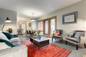 a living room with a couch and chairs and a table at Lovely 2BR Canmore Condo w Heated Pool and Hot Tub in Canmore