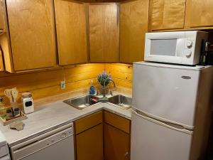 a kitchen with a white refrigerator and a sink at Cozy Cabin in Red River Gorge in Rogers +22 photos