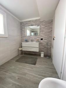 a bathroom with a sink and a mirror at Casa Dunja in Lecce
