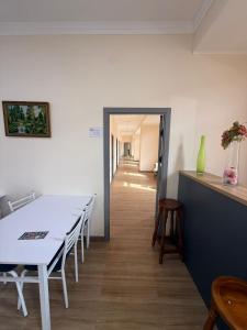 a dining room with a table and chairs and a hallway at Hostel in Tashkent