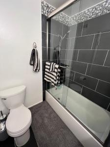 a bathroom with a toilet and a shower at Charming room in artist studio and Gallery in Santa Clarita +2 photos
