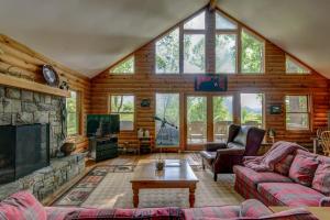 a living room with a couch and a fireplace at Banner Bunks at River Run in Banner Elk