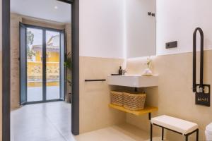 a bathroom with a sink and a table at Luxury Apartment overlooking Casa Pilatos in Seville +30 photos