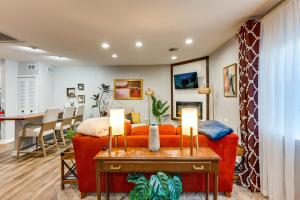 a living room with a red couch and a table at Unique, Convenient Couples Apt Near Dtwn Flushing in Flushing