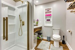a bathroom with a shower and a toilet at Unique, Convenient Couples Apt Near Dtwn Flushing in Flushing +16 photos