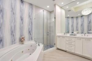 a bathroom with a tub and two sinks and a shower at Ultra-luxury Coastal Retreat in Pompano Beach +26 photos