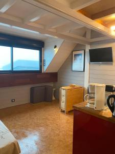 une chambre mansardée avec un lit et une grande fenêtre dans l'établissement Le Domaine du Lary, à Cadeilhan-Trachère 5 autres photos